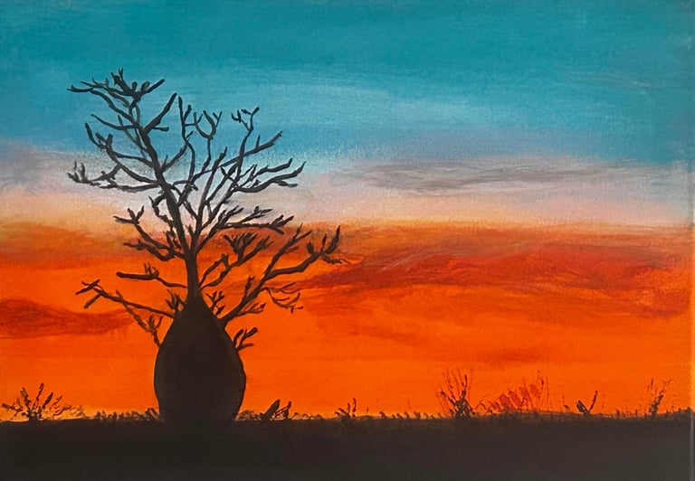 Silhouette of a bare, gnarled tree against a vibrant orange sunset sky with turquoise clouds