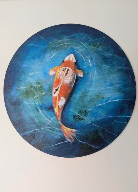 Aerial view of red and white koi fish swimming in circular blue water with swirling patterns